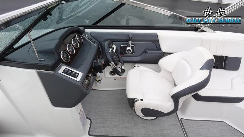 Slide: The Image of 2020 Chaparral 237 SSX boat cockpit with steering wheel and white seating. - 26