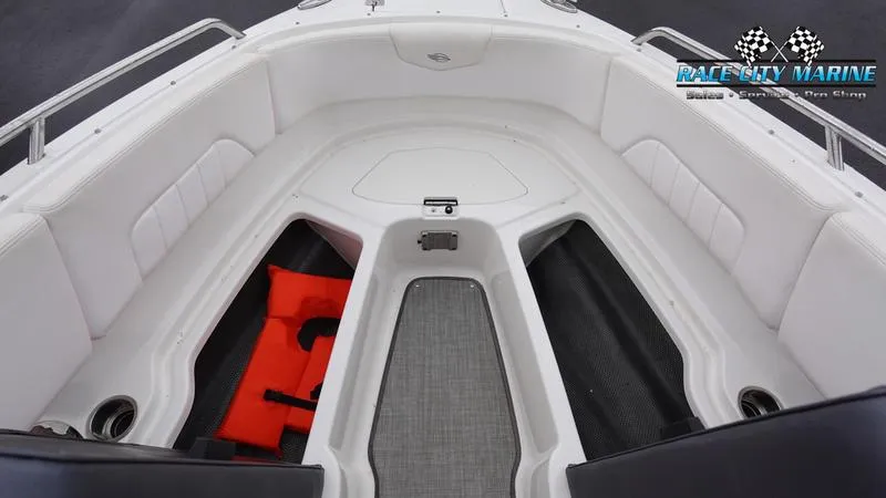Slide: The Image of 2020 Chaparral 237 SSX boat interior with seating and storage compartments. - 33