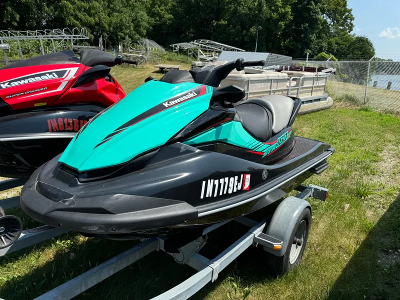 Slide: The Image of 2021 Kawasaki STX160X jet ski on trailer, parked outdoors near water. - 3