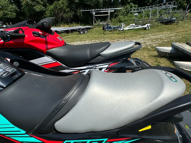 Slide: The Image of 2021 Kawasaki STX160X jet ski seats, parked outdoors on grass. - 4