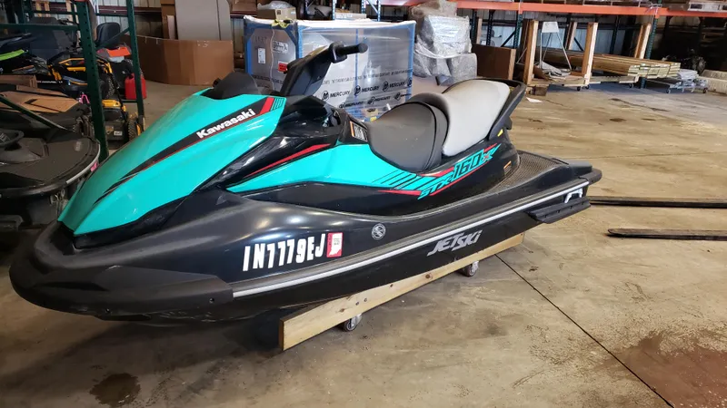 Slide: The Image of 2021 Kawasaki STX160X jet ski in a warehouse setting. - 5