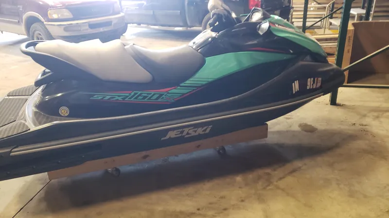Slide: The Image of 2021 Kawasaki STX160X jet ski in a garage setting. - 6