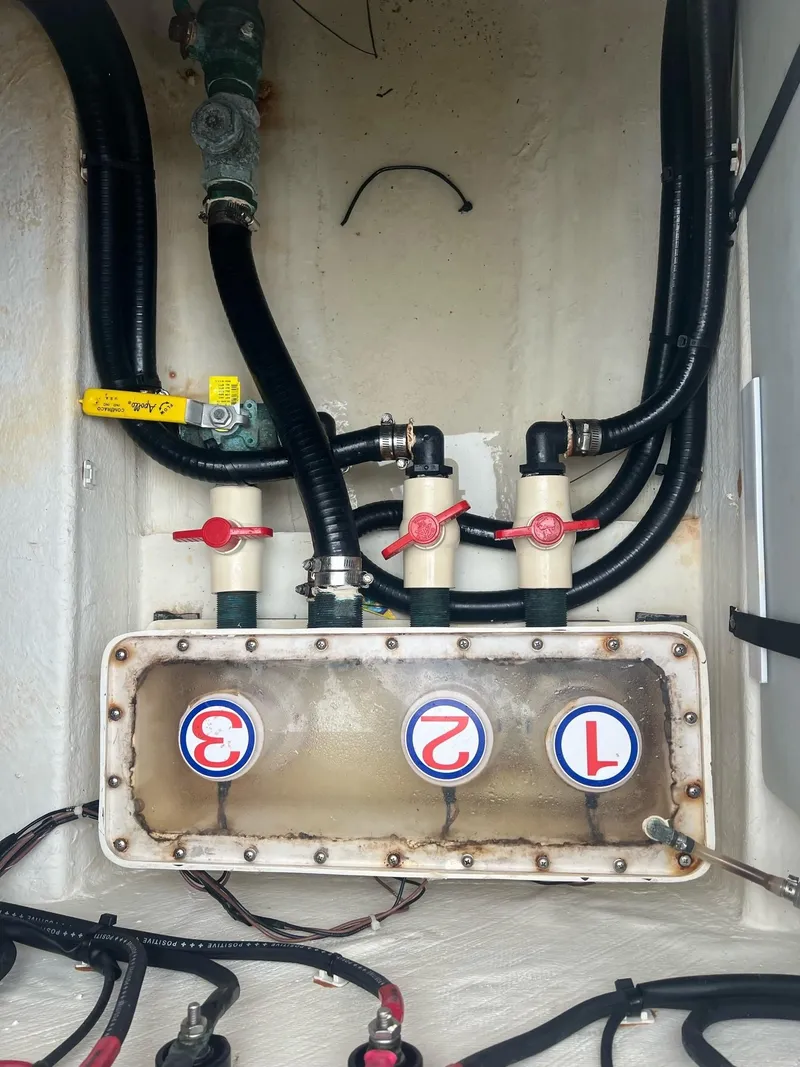 Slide: The Image of 2015 Cobia 344 Center Console boat plumbing system with labeled valves and hoses. - 15