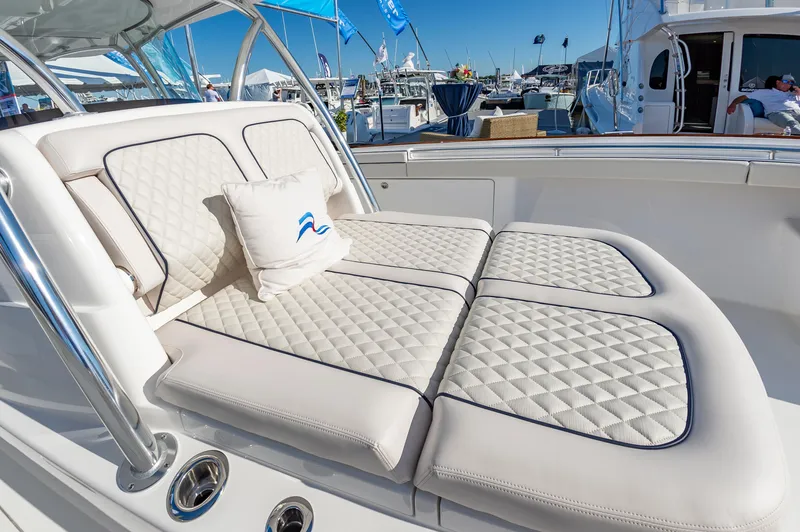 Slide: The Image of Luxurious seating on 2025 Valhalla Boatworks V-41, featuring quilted cushions and nautical decor. - 14