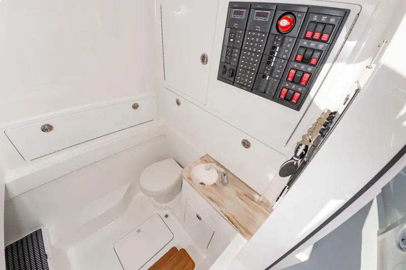 Slide: The Image of 2025 Valhalla Boatworks V-41 interior with control panel and compact bathroom. - 18