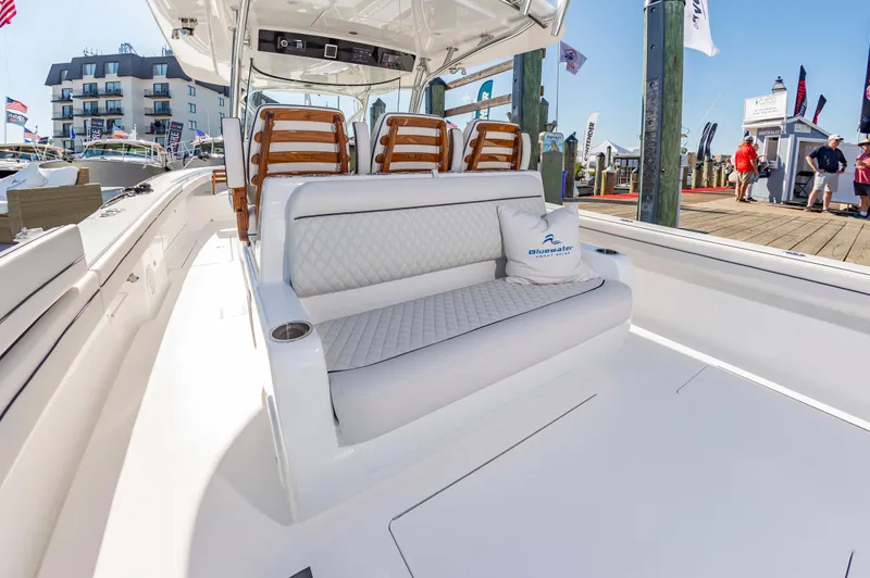 Slide: The Image of 2025 Valhalla Boatworks V-41 luxury seating area at a marina. - 7