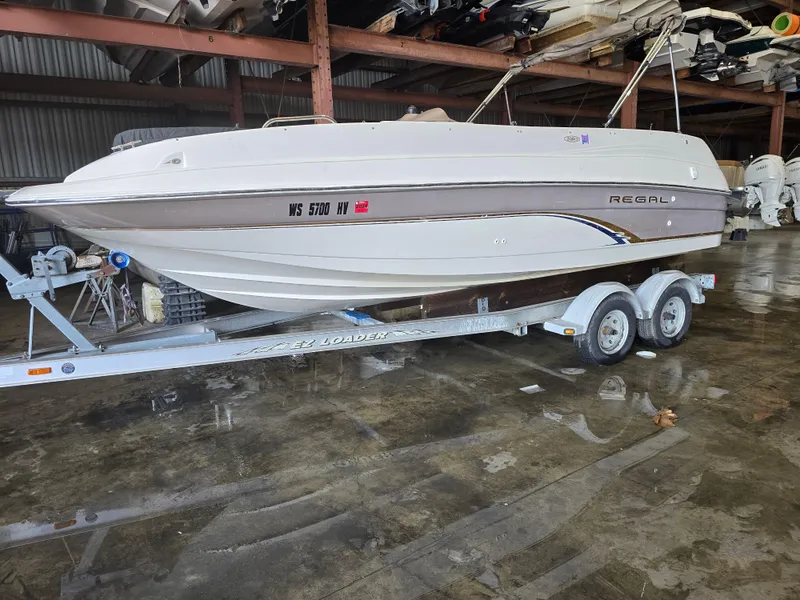 Slide: The Image of 1999 Regal Destiny 200 boat on EZ Loader trailer in indoor storage. - 1