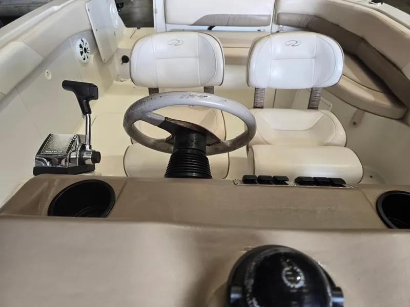 Slide: The Image of 1999 Regal Destiny 200 boat interior with steering wheel and control panel. - 13