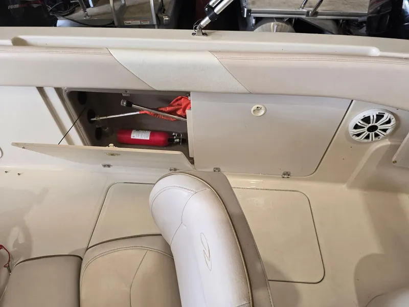 Slide: The Image of 1999 Regal Destiny 200 boat interior with open storage compartment and fire extinguisher. - 17