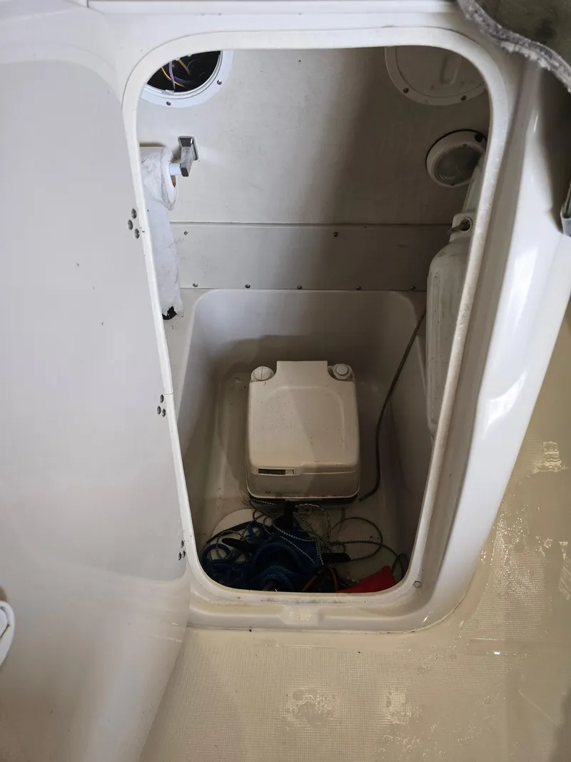Slide: The Image of Storage compartment of a 1999 Regal Destiny 200 boat with equipment inside. - 19