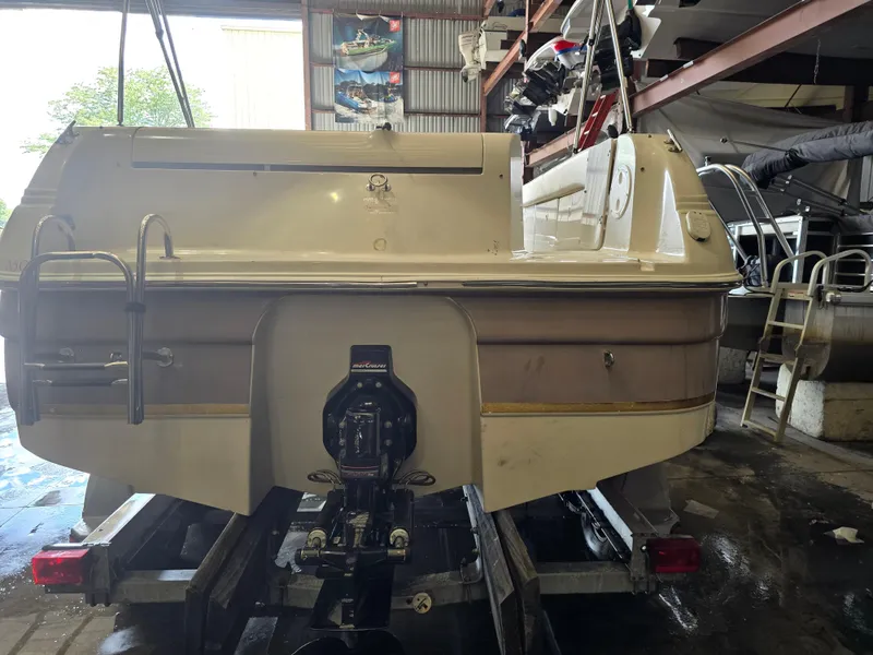 Slide: The Image of 1999 Regal Destiny 200 boat in storage, rear view with ladder and outboard motor. - 4