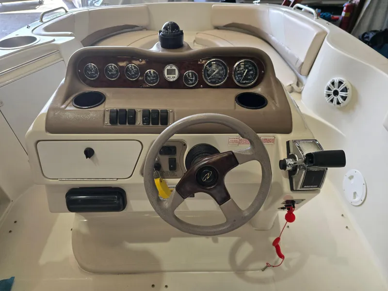 Slide: The Image of 1999 Regal Destiny 200 boat dashboard with steering wheel and control panel. - 5