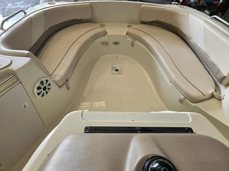 Slide: The Image of 1999 Regal Destiny 200 boat interior with beige seating and speaker. - 7
