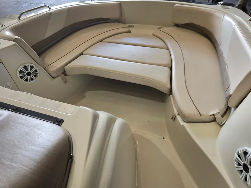 Slide: The Image of 1999 Regal Destiny 200 boat interior with beige seating and built-in speakers. - 8