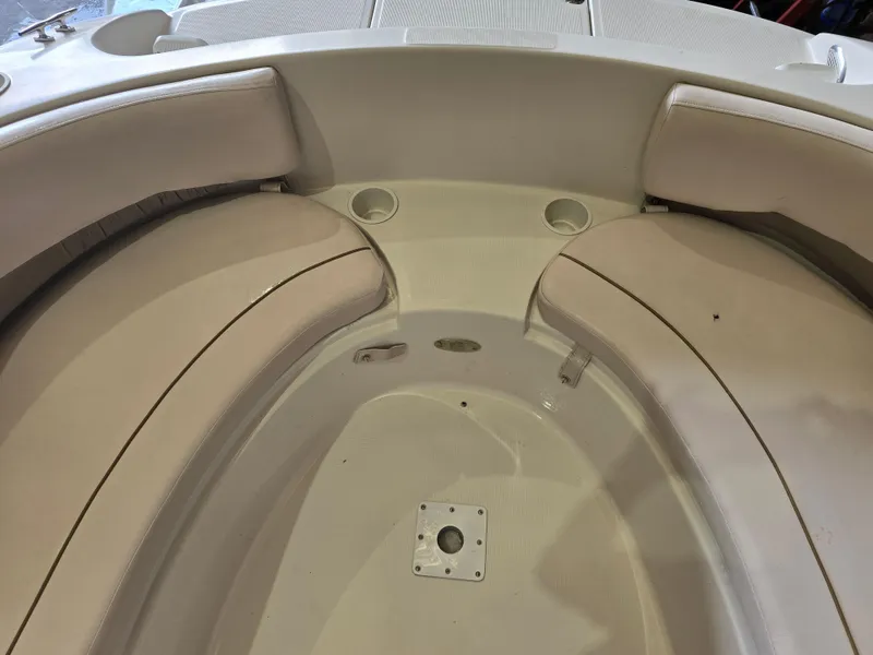 Slide: The Image of 1999 Regal Destiny 200 boat interior with cushioned seating and cup holders. - 9