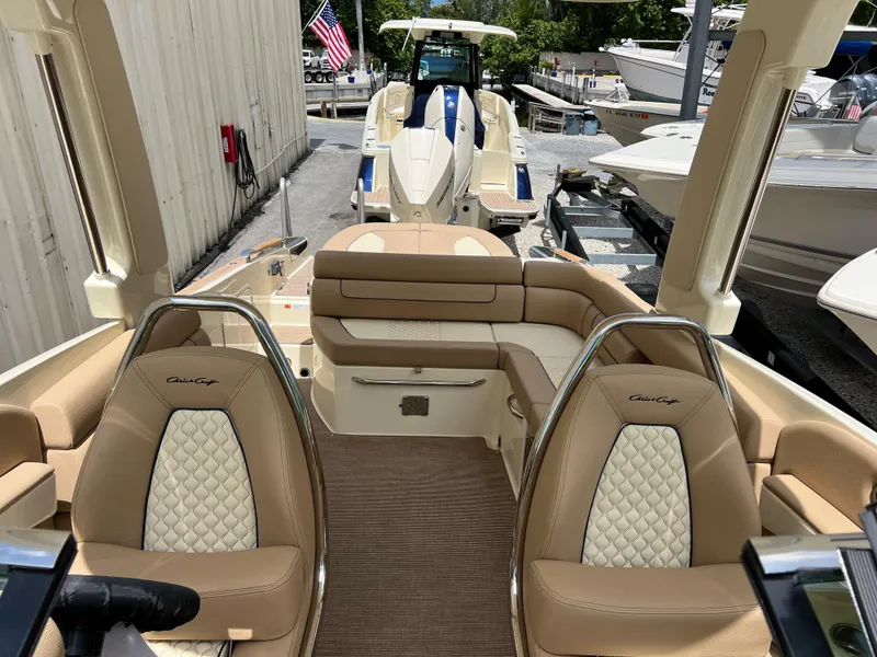 Slide: The Image of 2024 Chris-Craft Launch 25 GT boat interior with tan leather seats and elegant design. - 14