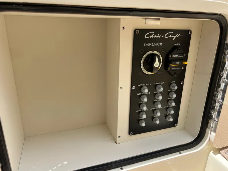 Slide: The Image of Control panel of 2024 Chris-Craft Launch 25 GT boat, featuring engine and house switches. - 15