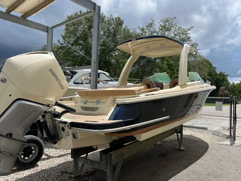 Slide: The Image of 2024 Chris-Craft Launch 25 GT boat with Mercury outboard motor on display. - 2