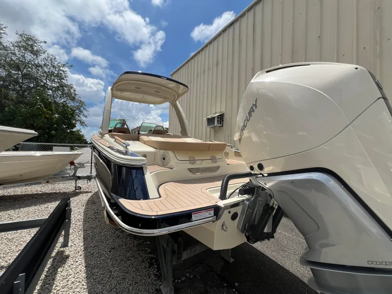 Slide: The Image of 2024 Chris-Craft Launch 25 GT boat with Mercury outboard motor, docked outdoors. - 3