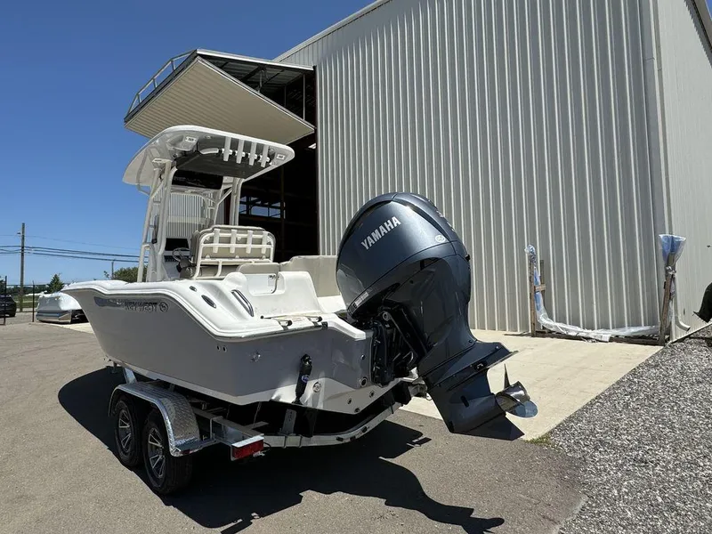 Slide: The Image of 2024 Key West 239 FS boat with Yamaha engine outside a storage facility. - 2