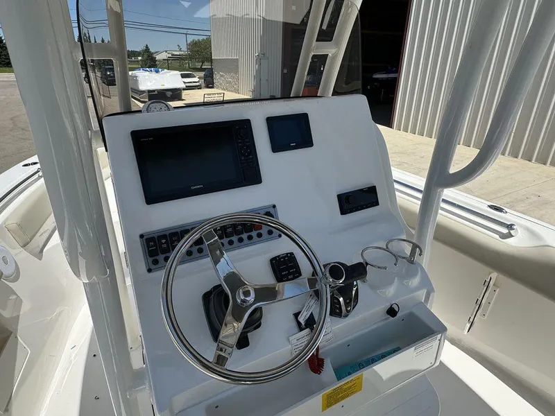 Slide: The Image of 2024 Key West 239 FS boat console with steering wheel and navigation controls. - 5