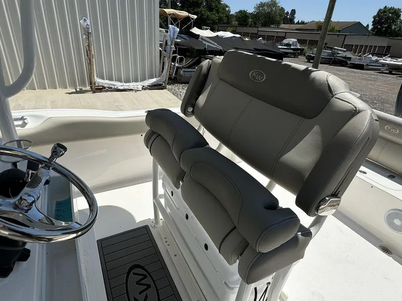 Slide: The Image of 2024 Key West 239 FS boat interior with steering wheel and cushioned seats. - 6