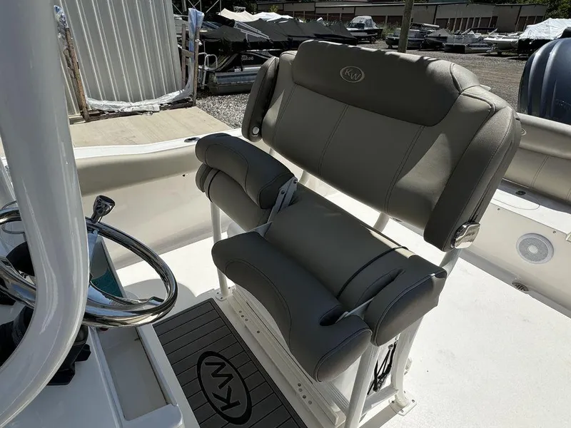 Slide: The Image of 2024 Key West 239 FS boat interior with cushioned seating and steering wheel. - 8