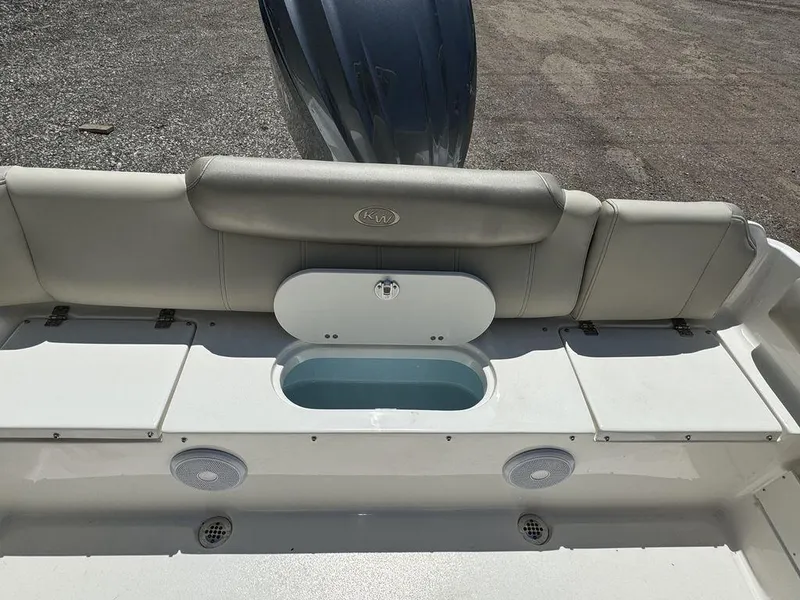 Slide: The Image of 2024 Key West 239 FS boat rear seating and storage compartments. - 9