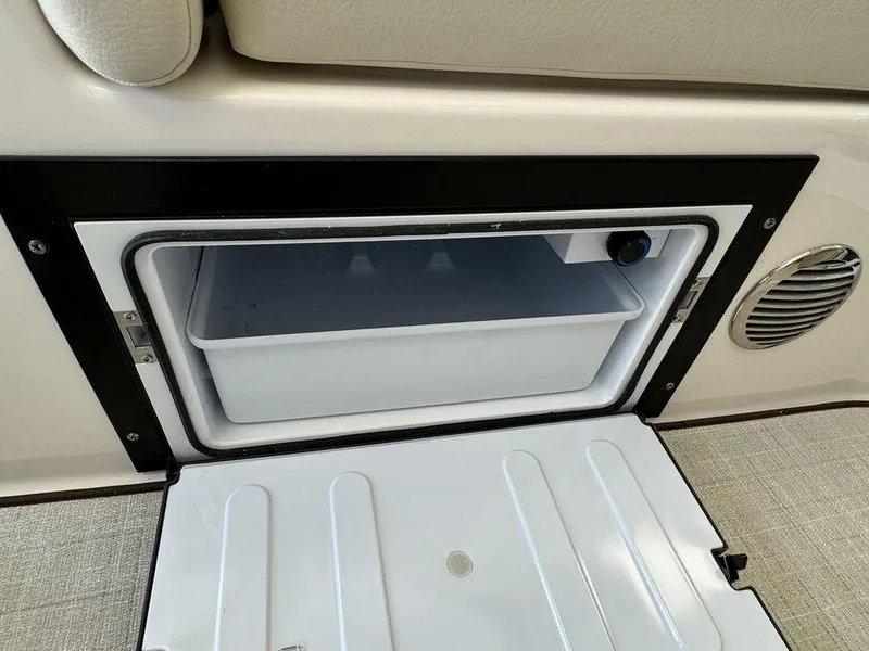 Slide: The Image of Open storage compartment in 2025 Regal 28X boat interior. - 11