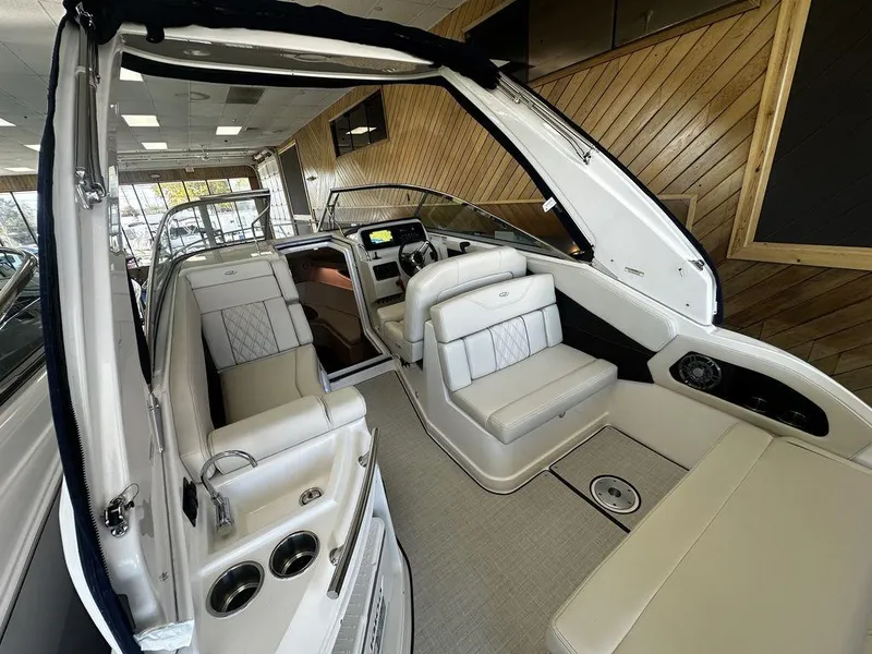 Slide: The Image of Interior of 2025 Regal 28X boat with luxurious seating and modern dashboard. - 5