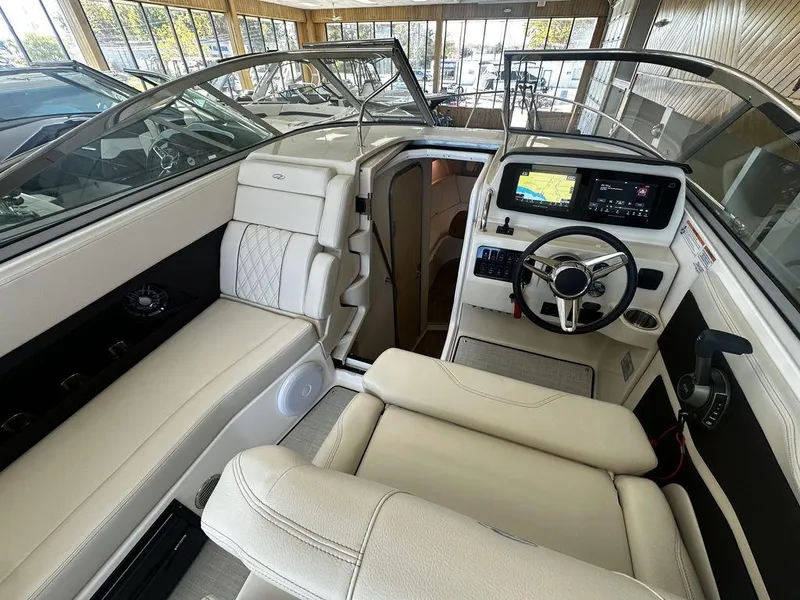 Slide: The Image of Interior of 2025 Regal 28X boat with modern dashboard and luxurious seating. - 7