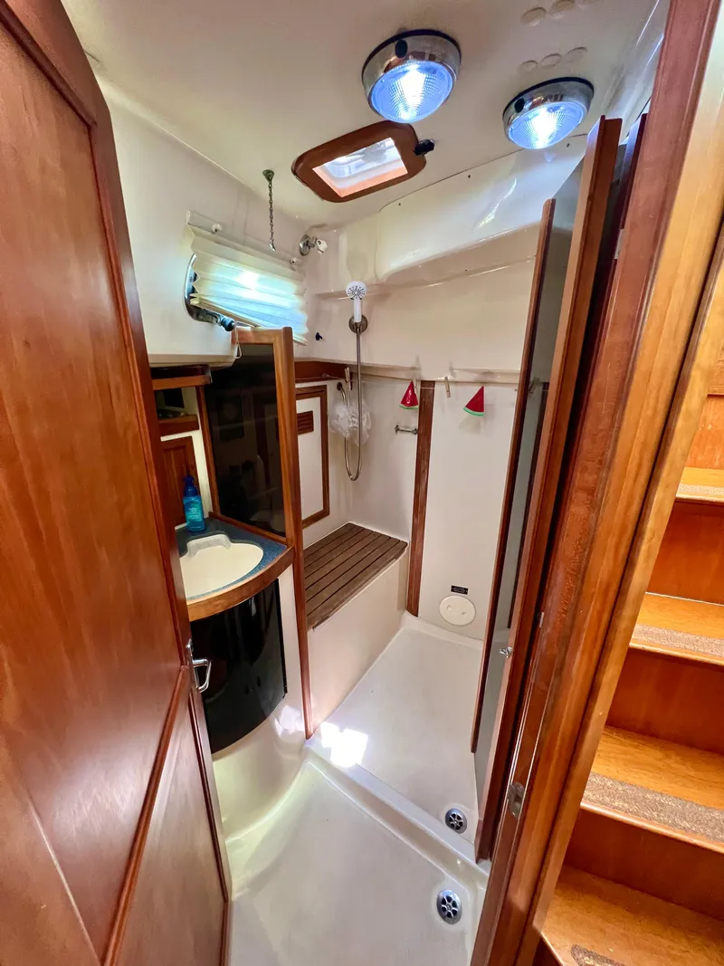 Slide: The Image of 1999 Sabre 402 yacht bathroom with wooden cabinetry and modern fixtures. - 15