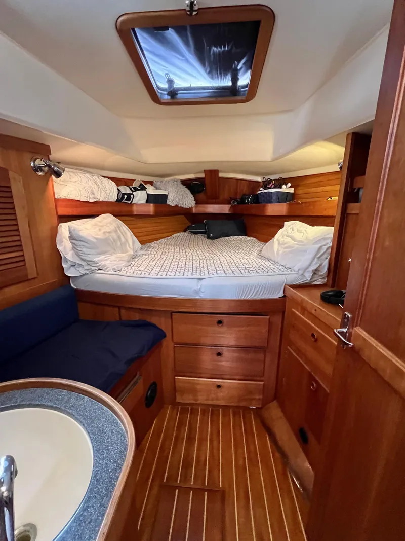 Slide: The Image of 1999 Sabre 402 sailboat interior with cozy wooden cabin and double bed. - 2