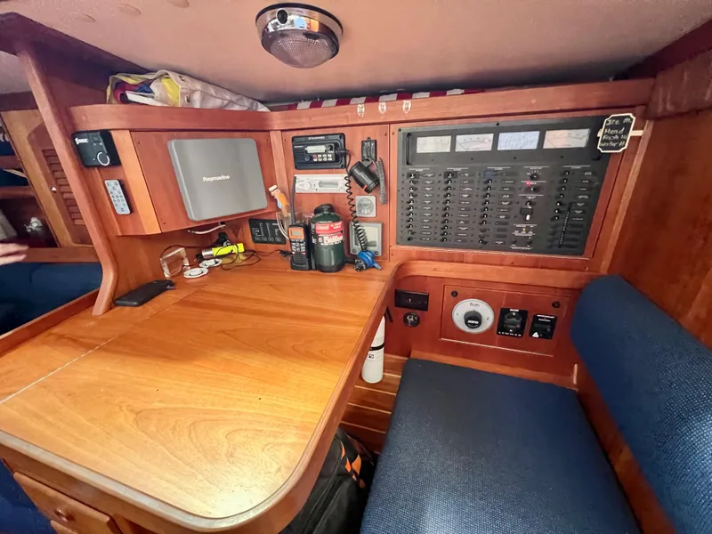 Slide: The Image of Navigation station of a 1999 Sabre 402 sailboat with control panels and equipment. - 23