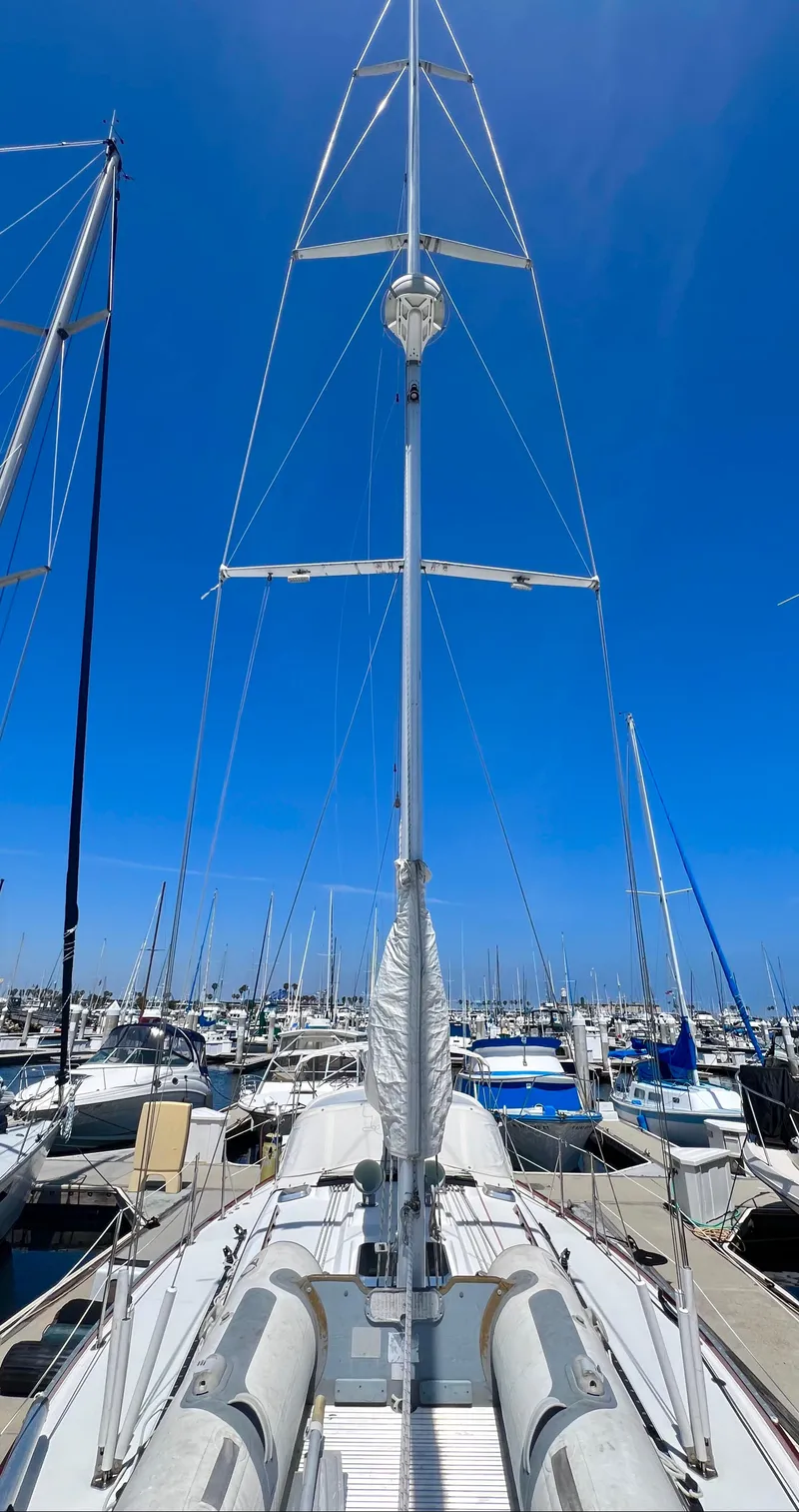 Slide: The Image of Sailboat Sabre 402, 1999 model, docked at a marina under a clear blue sky. - 27