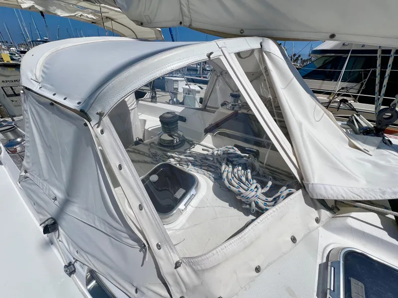 Slide: The Image of 1999 Sabre 402 sailboat cockpit with white canvas cover and rigging. - 28