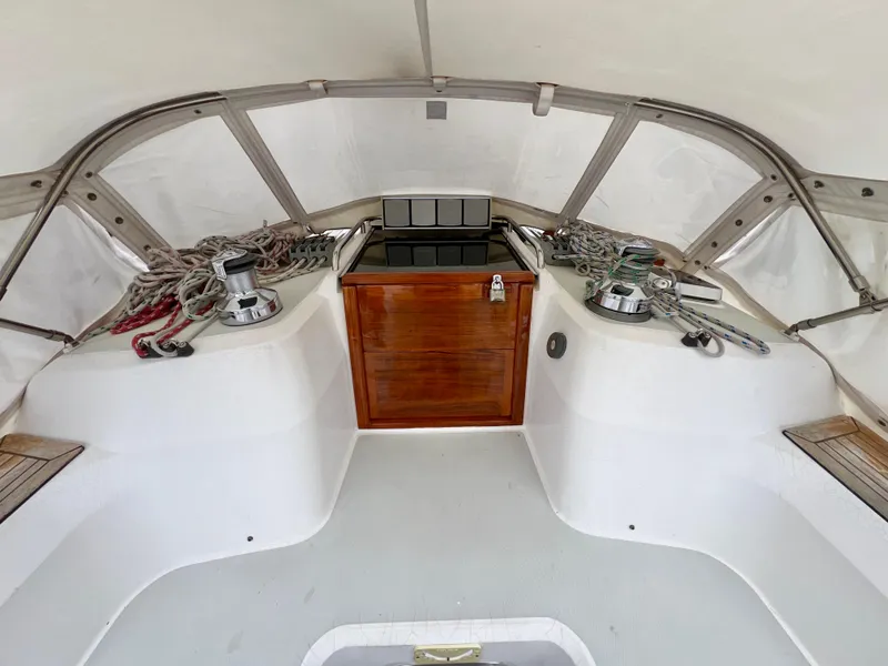 Slide: The Image of 1999 Sabre 402 sailboat cockpit with winches, ropes, and wooden hatch. - 35