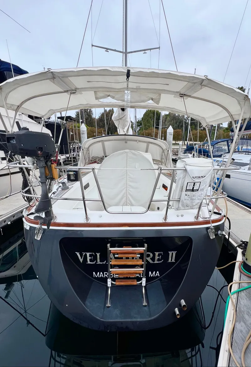 Slide: The Image of 1999 Sabre 402 sailboat docked, rear view with canopy and ladder. - 37