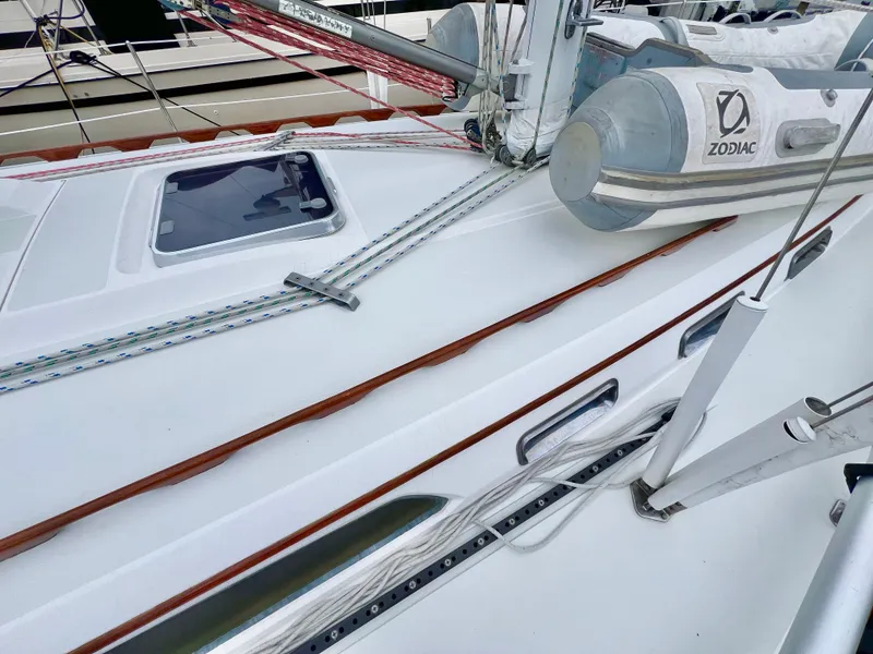 Slide: The Image of 1999 Sabre 402 sailboat deck with rigging and Zodiac dinghy. - 43