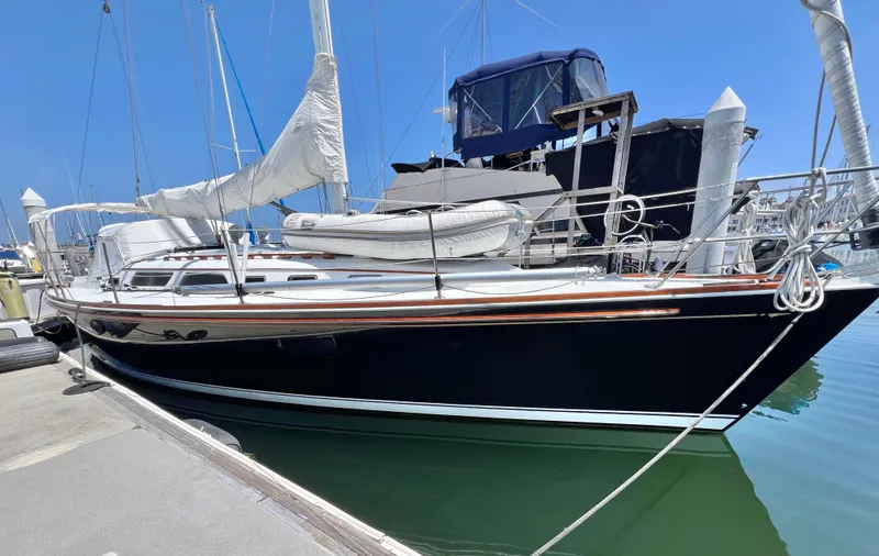 Slide: The Image of 1999 Sabre 402 sailboat docked at marina on a sunny day. - 44