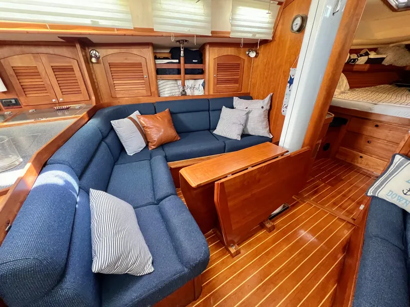 Slide: The Image of Interior of a 1999 Sabre 402 sailboat with blue seating and wooden finishes. - 9