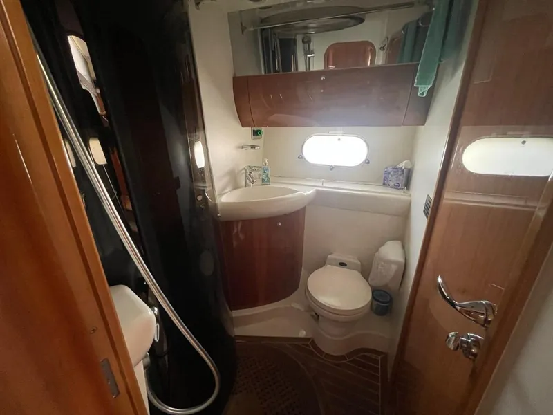 Slide: The Image of 2001 Viking Princess 45 Flybridge Sport Cruiser bathroom with shower, sink, and toilet. - 14