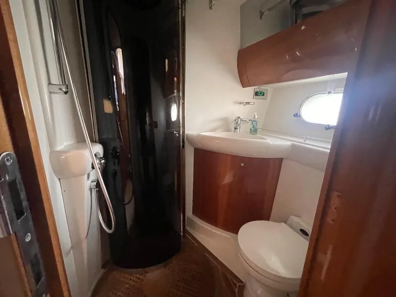 Slide: The Image of 2001 Viking Princess 45 Flybridge Sport Cruiser bathroom with shower, sink, and toilet. - 15