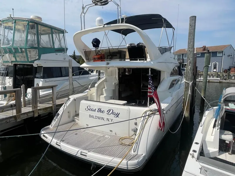 Slide: The Image of 2001 Viking Princess 45 Flybridge Sport Cruiser docked at marina, Seas the Day Baldwin, NY. - 2