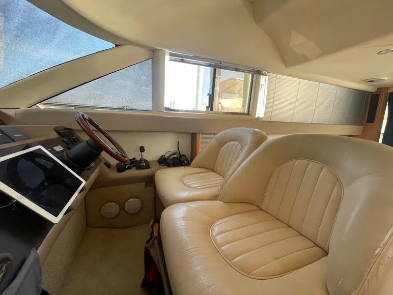 Slide: The Image of Interior of 2001 Viking Princess 45 Flybridge Sport Cruiser with leather seating and navigation equipment. - 22