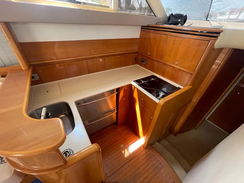 Slide: The Image of 2001 Viking Princess 45 Flybridge Sport Cruiser kitchen with wood cabinetry and modern appliances. - 23