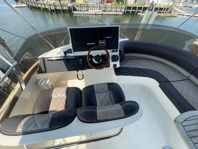 Slide: The Image of 2001 Viking Princess 45 Flybridge Sport Cruiser helm station with dual seats and navigation equipment. - 27