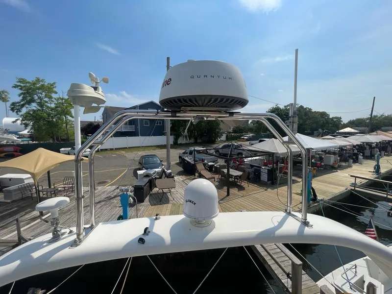 Slide: The Image of Viking Princess 45 Flybridge Sport Cruiser 2001 docked, showcasing radar and navigation equipment. - 28
