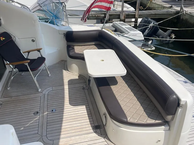 Slide: The Image of Viking Princess 45 Flybridge Sport Cruiser 2001, outdoor seating area with table and chair. - 6
