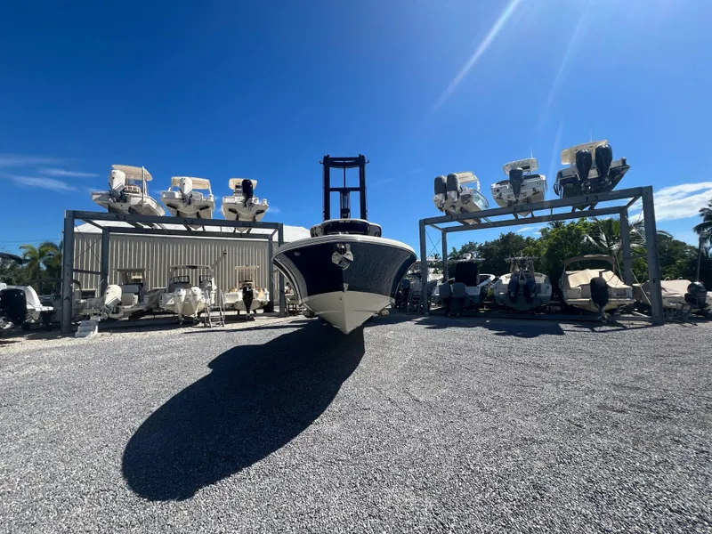 Slide: The Image of 2024 Chris-Craft Catalina 30 boat in storage yard under clear blue sky. - 2